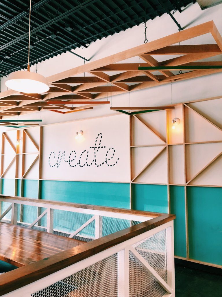 Office wall with the word create on it.