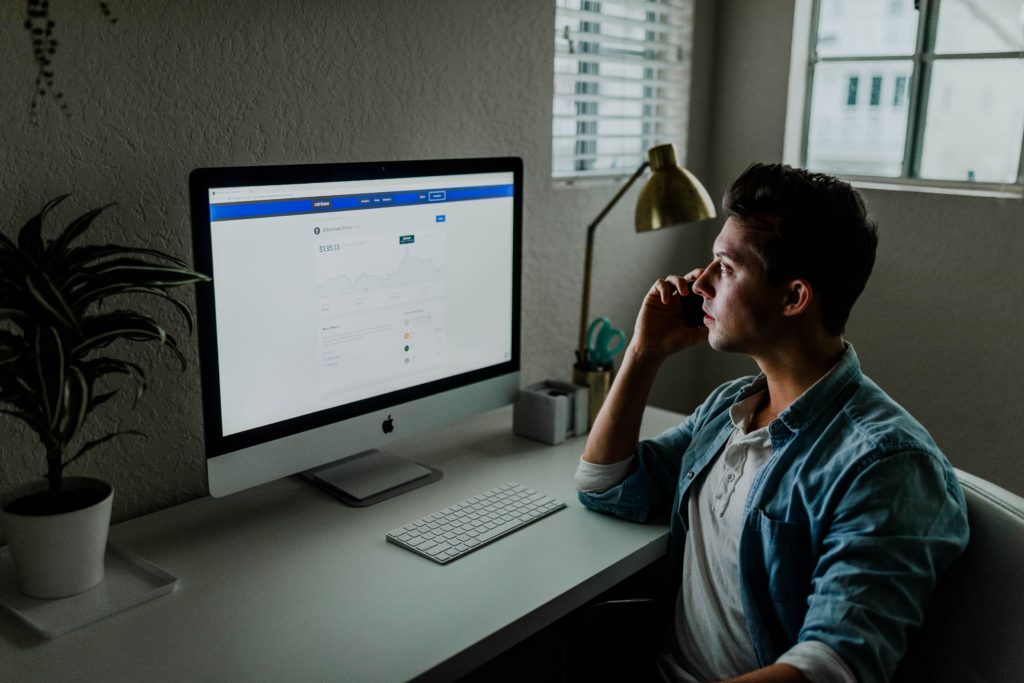 Man sitting in front of his computer wondering, "How to increase local traffic to my website?"