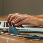 Health care practitioner on her laptop creating online marketing content for her practice.
