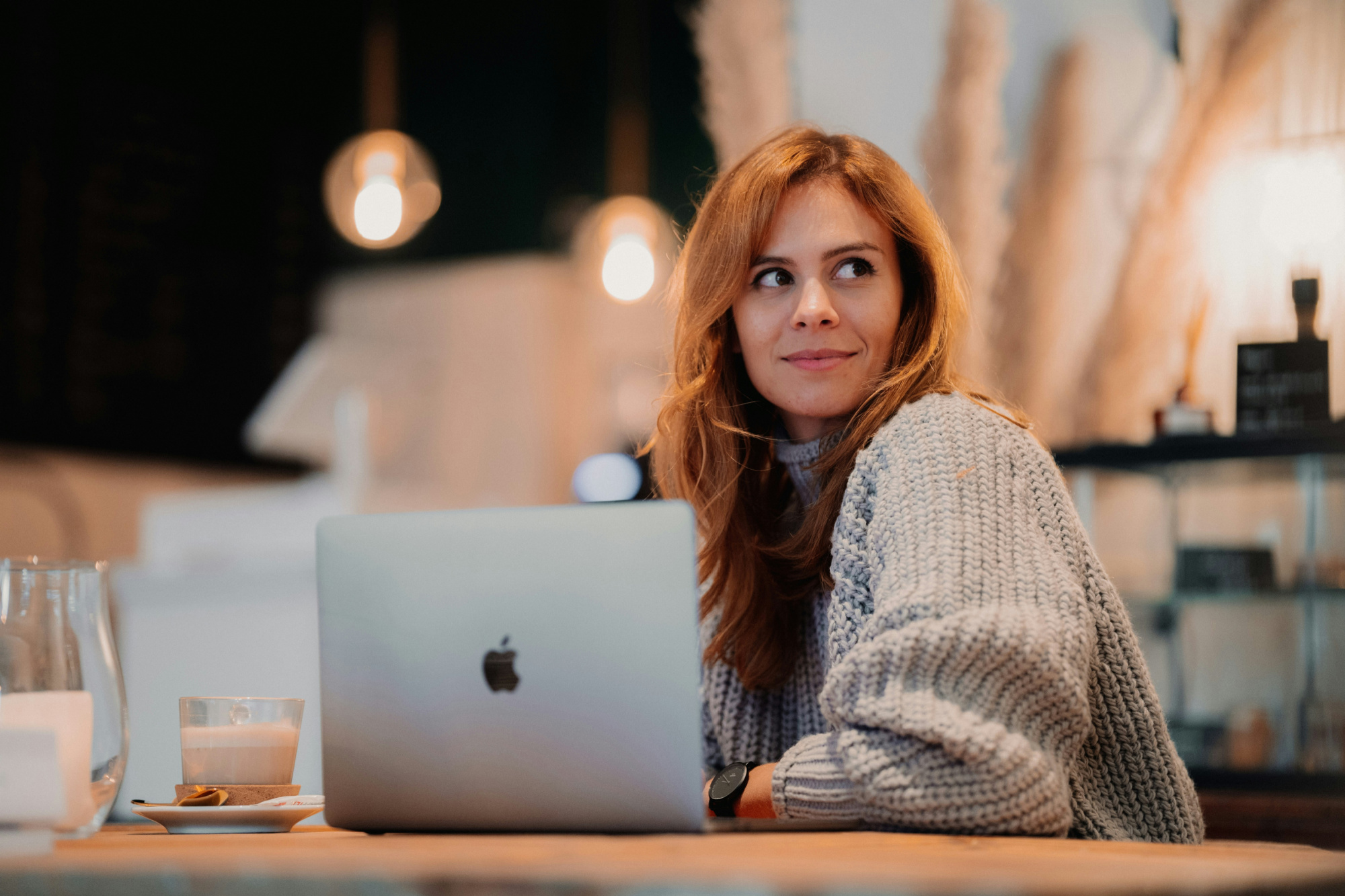 Woman sitting at her laptop wondering how to improve her digital content marketing strategy.