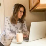 Woman working on her laptop to boog traffic to her website.