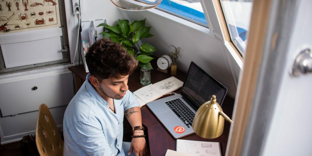 Business owner sitting at desk putting together a plan to begin blogging for his business.