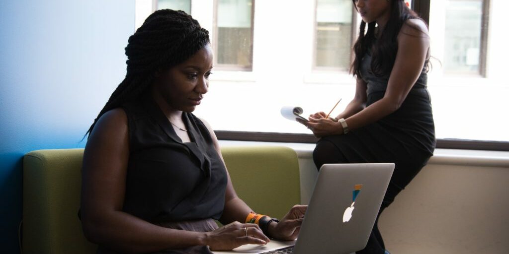 Two women working together on blogging for their business.