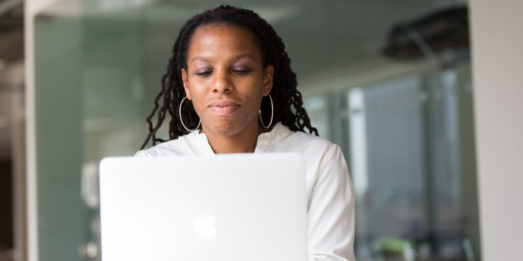 Woman working on her laptop to build her email list.