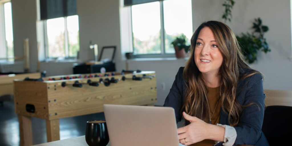 Woman sitting in front of her latptop talking about blogging to promote your business.