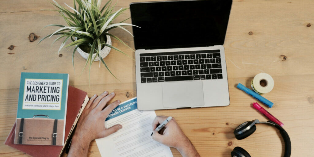 Man working on using the online marketing tips he read in a book.