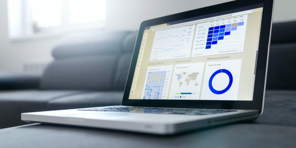 Laptop showing graphs of SEO online marketing results.