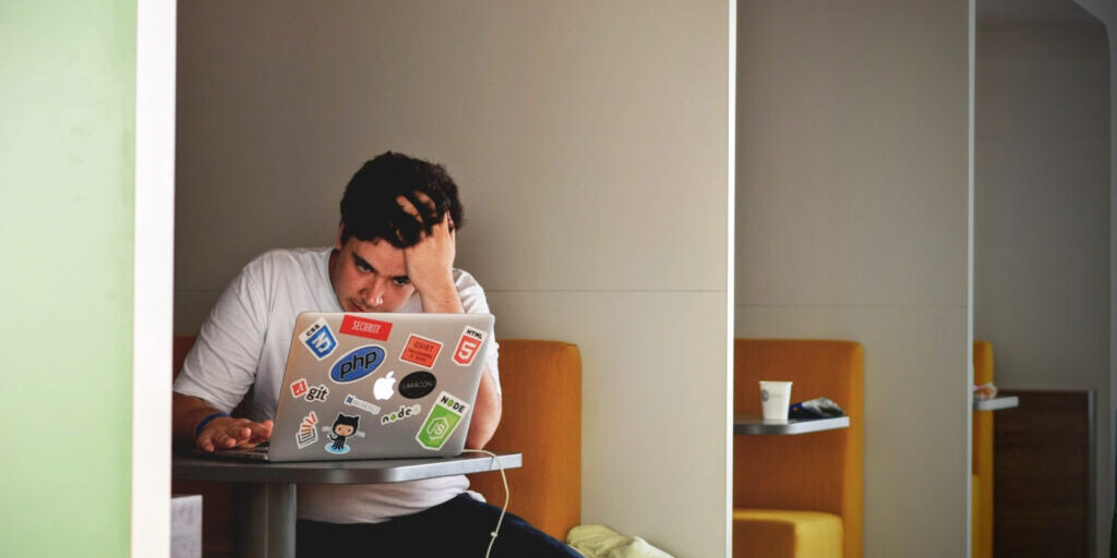 Man working at his computer trying to understand why his content marketing is failing.