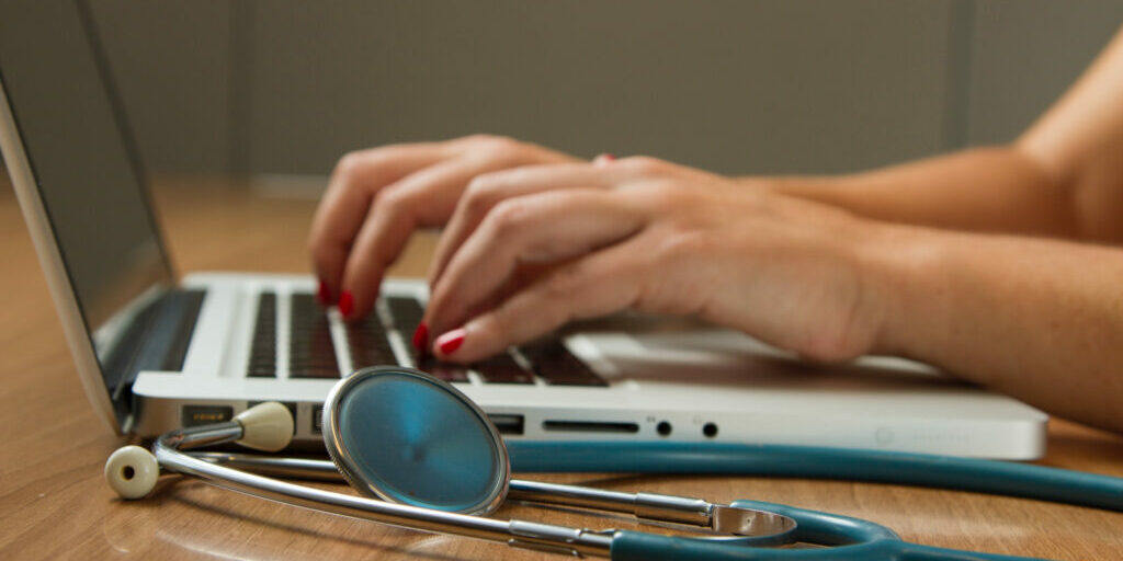 Health care practitioner on her laptop creating online marketing content for her practice.